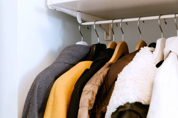 istock Clothes on the rail in the wardrobe. Minimalism, declutter your home 1023127750