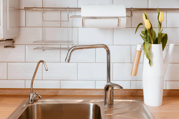 istock White grey kitchen room organization. Pure water and clear sink 1023127754