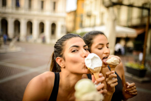 istock Two sporty women eating ice cream. 1023131440