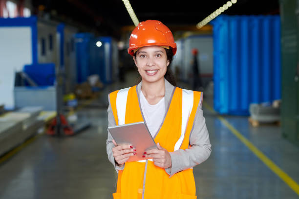 istock Female Factory Worker in Orange Uniform 1023136584