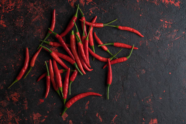 istock Red hot chili peppers on old wooden table with place for text 1023138980