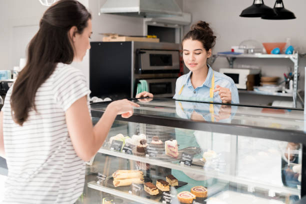 Young Woman Working in Cake Shop