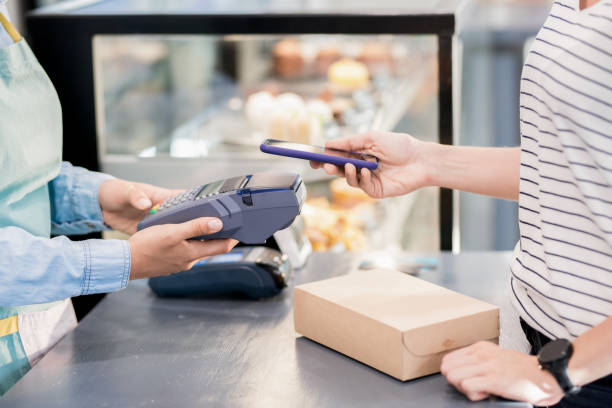 istock Unrecognizable Woman Paying by Smartphone 1023139420