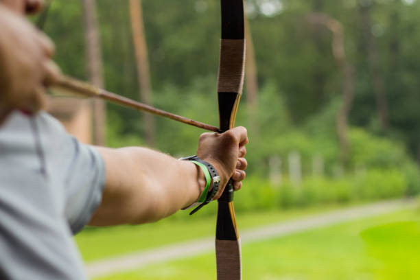 istock Aiming archers on the green clear background 1023145546
