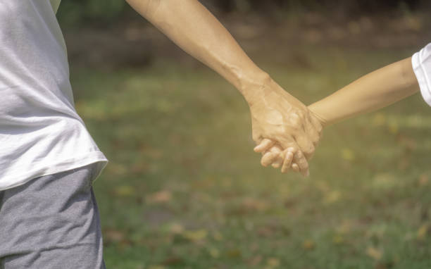 istock Holding hand kid in the park 1023153470