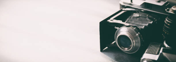istock Retro cameras on gray table background 1023159524