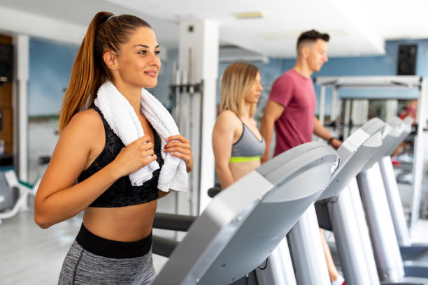 istock Group of young athletes jogging on treadmills in a gym 1023164792