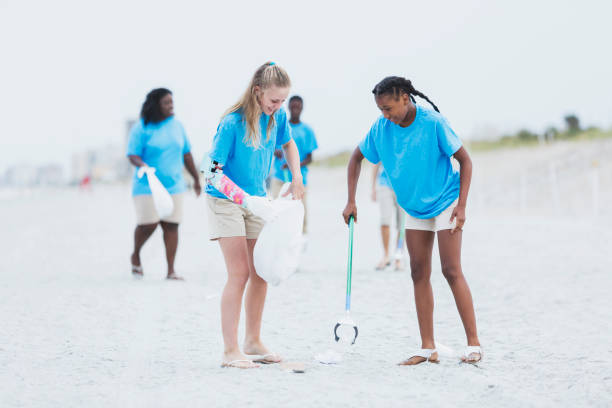 istock Volunteers picking up trash from beach 1023179586