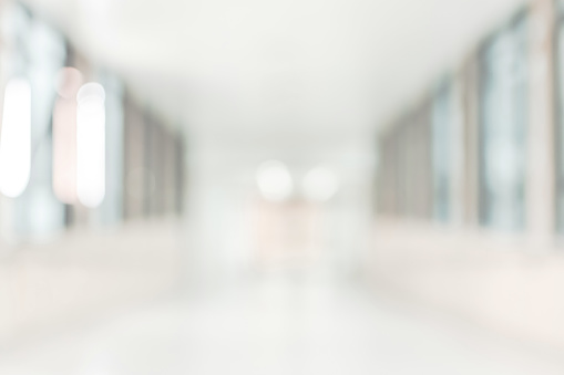 Medical clinic blur background healthcare hospital service center in patientâs ward blurry perspective view of interior white room, lab corridor hallway, lobby or walkway for nursing care service facility
