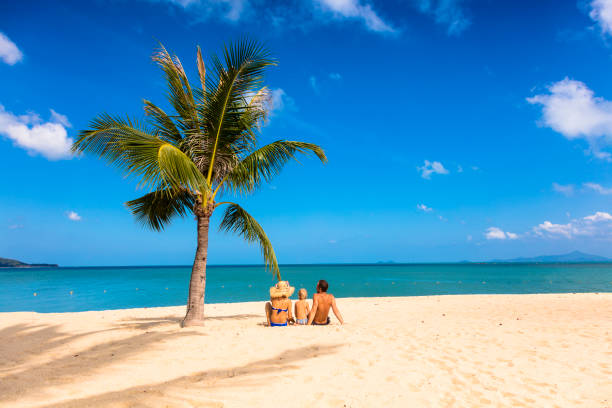 istock Family sitting at the beach 1023182318