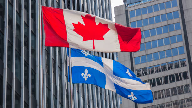quebec y canadá banderas ondeando en el viento junto en el centro de montreal. - canadian province fotografías e imágenes de stock