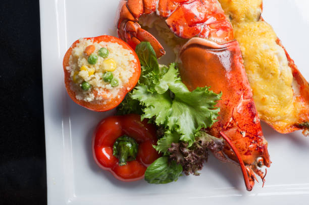 istock Close up lobster bake with cheese sliced in half serviced with fire rice in tomato. 1023185202