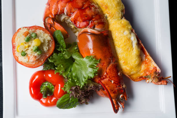 istock Close up lobster bake with cheese sliced in half serviced with fire rice in tomato. 1023185222