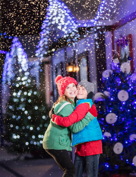istock Two children, siblings, hugging at winter festival 1023194202