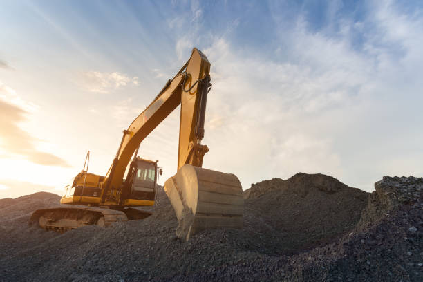 istock Backhoe used in construction, Big excavator on new construction site, in the background the blue sky and sun. 1023194354