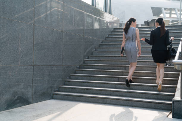 istock modern business woman climbing stairs. 1023201774