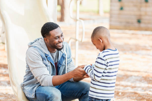 istock Father talking to little boy on playground, smiling 1023204330