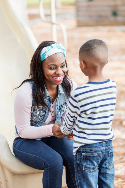 istock Mother talking to little boy on playground, smiling 1023204344