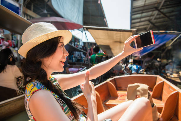 istock Woman taking selfie with floating market. 1023204424