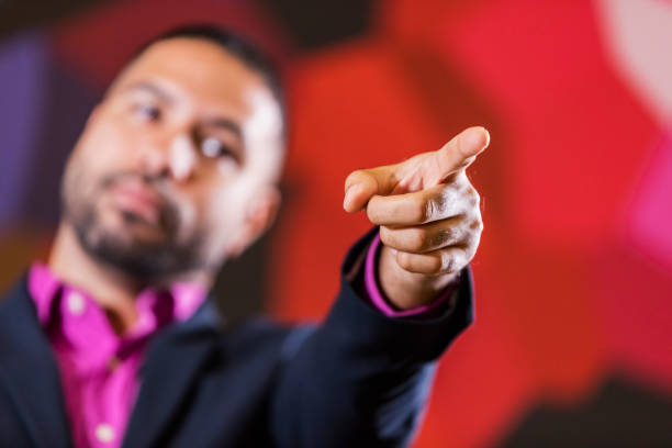 istock Mixed race man in business suit pointing index finger 1023204744