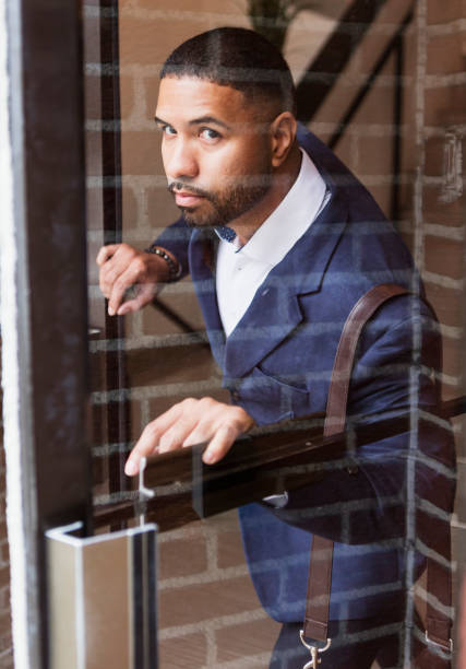 istock Mixed race man opening exterior door, leaving work 1023205186