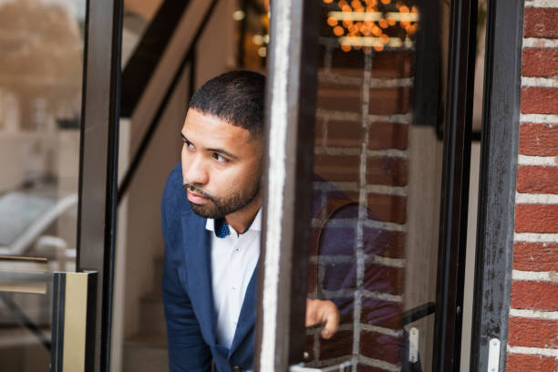 istock Mixed race man opening exterior door, leaving work 1023206960