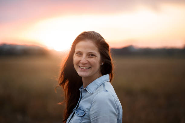 istock Smiling woman posing at sunset 1023211822