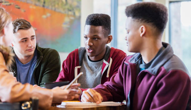 Multi-ethnic teenage friends studying together