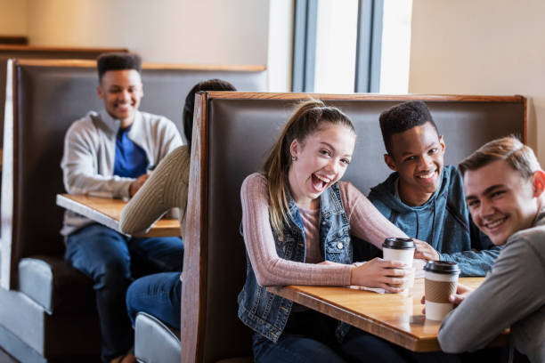 Teenagers sitting in restaurant booths