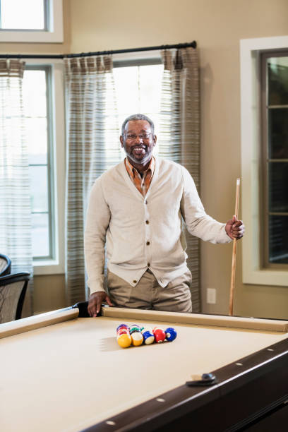 istock Mature African-American man shooting pool 1023214250