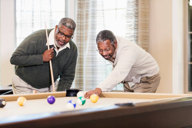 istock Two African-American men playing billiards 1023214402