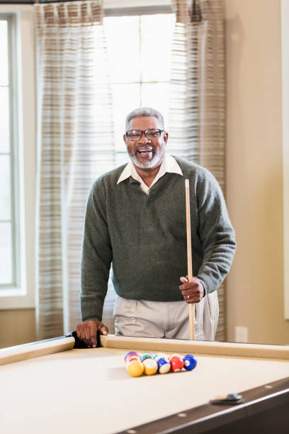 istock Senior African-American man shooting pool 1023214404