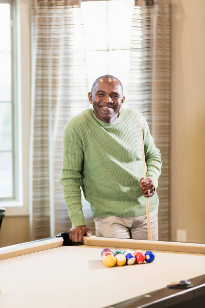 istock Mature African-American man shooting pool 1023214492