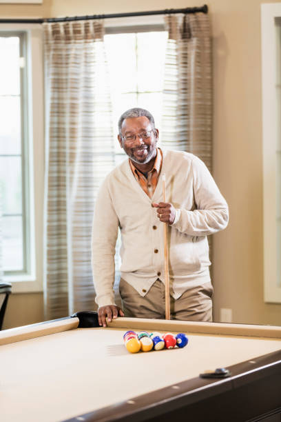 istock Mature African-American man shooting pool 1023214510