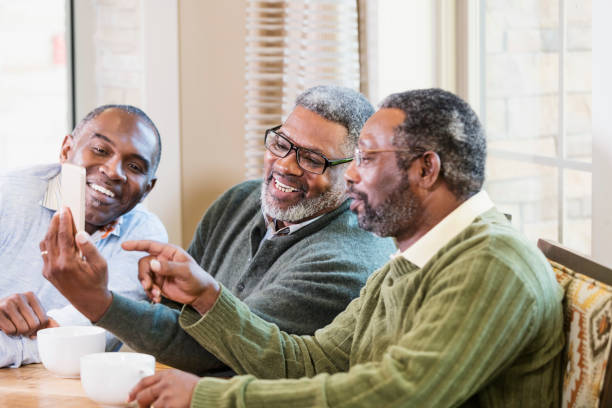 istock Three African-American men looking at mobile phone 1023221098