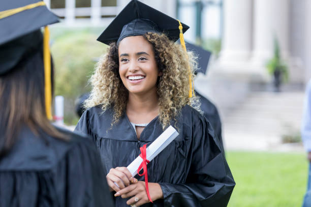 istock Pretty college graduate with diploma 1023227210