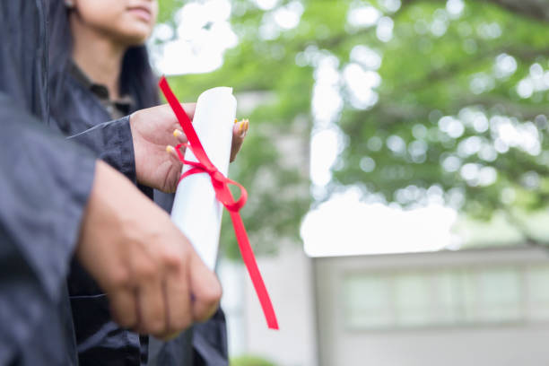 istock Unrecognizable college graduates with diplomas 1023227260