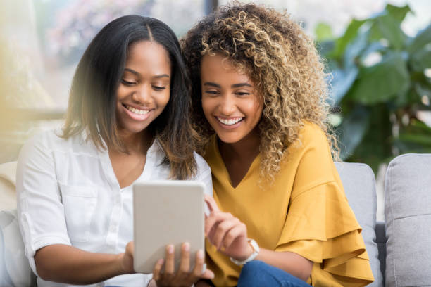 istock Cheerful female friends video chat with digital tablet 1023229524