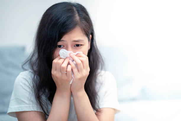 istock Young woman runny nose at home 1023236096