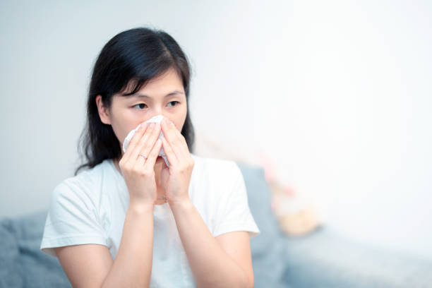 istock Young woman runny nose at home 1023236110