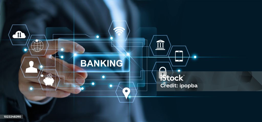 Businessman holding word banking in hand with icon network connection on virtual screen dark background Banking Stock Photo