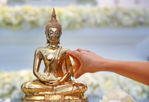 istock People blessing holy water and pay respects to Buddha statue. 1023260348