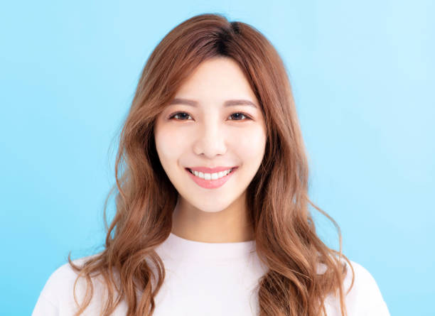 istock closeup young smiling woman face 1023260418