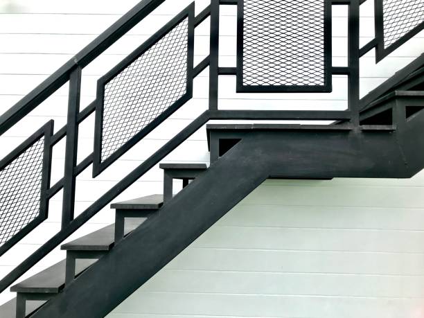istock Black steel stairs on a white wall 1023265462
