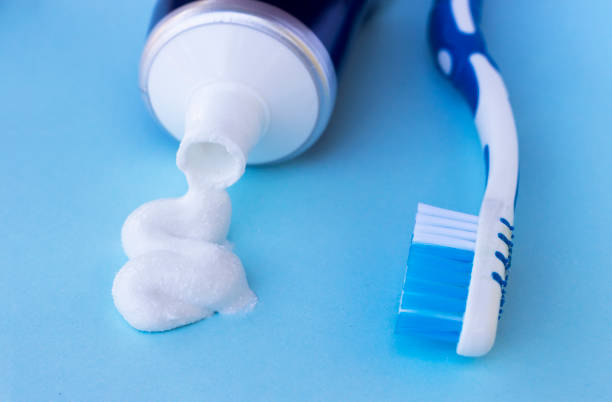 istock Toothpaste squeezed out from tube on blue background. Dental hygiene concept. 1023272368