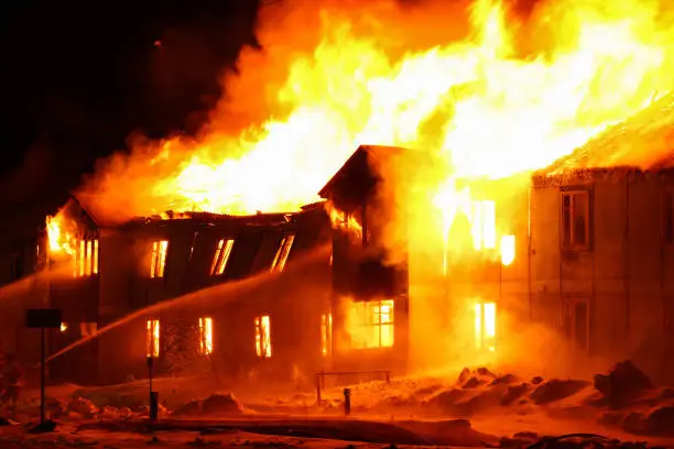 Burning old wooden house at night