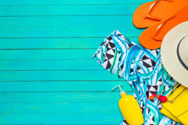istock Composition with swimsuit on color wooden background 1023311874