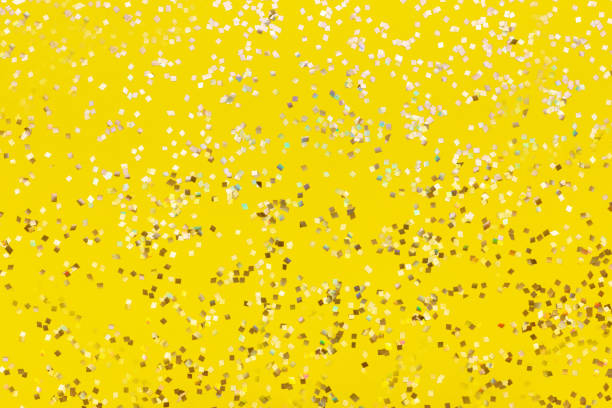 istock Seamless gold glitter texture isolated on yellow background. 1023317344