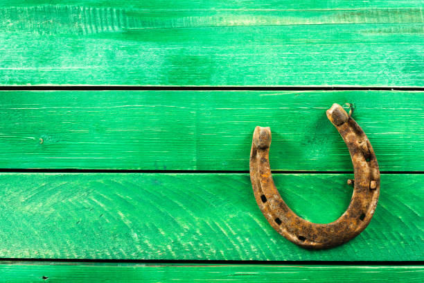 istock old rusty horseshoes on wooden board 1023325348