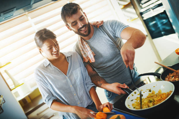 istock Young couple cooking at home. 1023335444